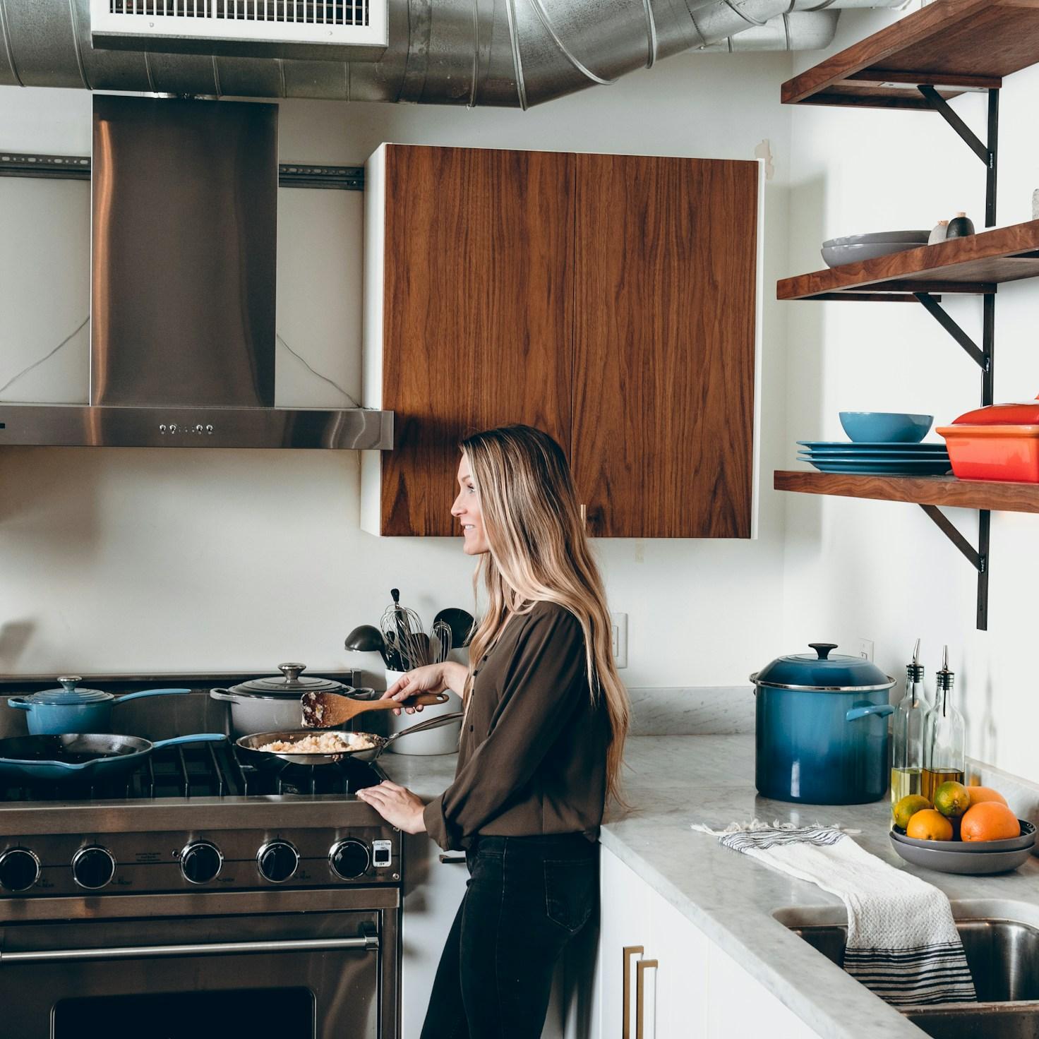 Community members collaborating in a modern kitchen space, sharing recipes and cooking techniques